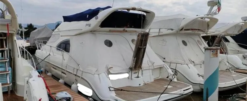  Yacht Photos Pics 2004 Cranchi Atlantique 40 yacht docked at marina, rear view.