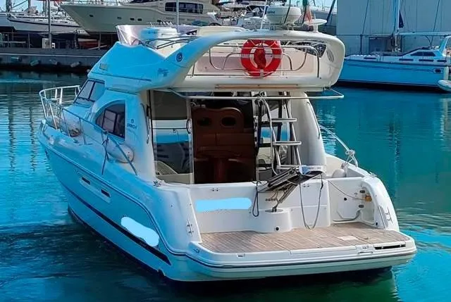  Yacht Photos Pics 2004 Cranchi Atlantique 40 yacht docked in marina, rear view with visible deck and ladder.