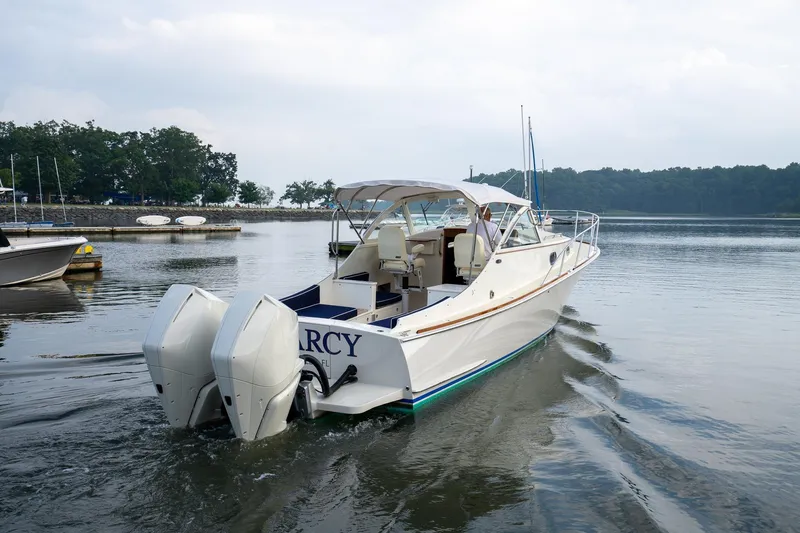 Marcy Yacht Photos Pics 2021 Brooklin Boat Yard 32 Express cruising on calm waters near a marina.