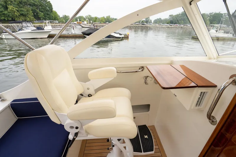 Marcy Yacht Photos Pics Luxurious interior of 2021 Brooklin Boat Yard 32 Express with cream seating and wooden accents.