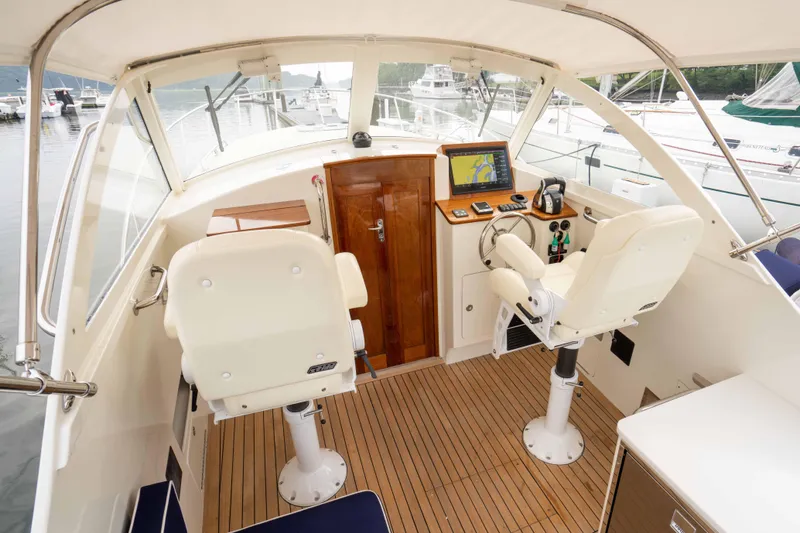 Marcy Yacht Photos Pics 2021 Brooklin Boat Yard 32 Express cockpit with helm, navigation equipment, and seating.