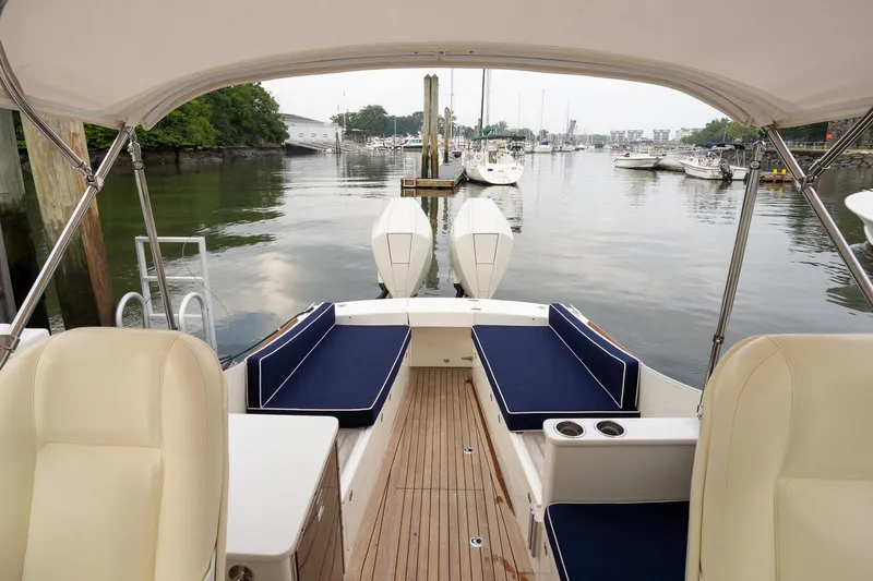 Marcy Yacht Photos Pics 2021 Brooklin Boat Yard 32 Express, elegant interior, docked in a serene marina setting.