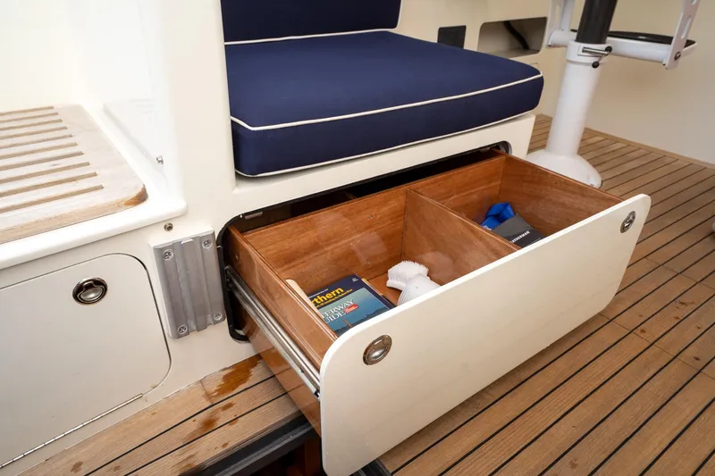 Marcy Yacht Photos Pics 2021 Brooklin Boat Yard 32 Express interior with open storage drawer on wooden deck.