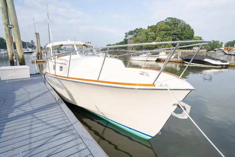 Marcy Yacht Photos Pics 2021 Brooklin Boat Yard 32 Express docked at marina, calm water, clear sky.