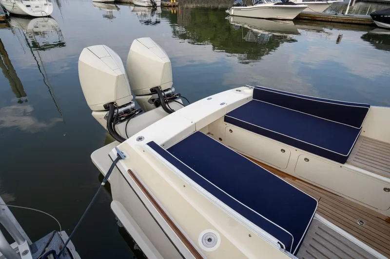 Marcy Yacht Photos Pics Brooklin Boat Yard 32 Express 2021 with twin engines and navy seating in a marina.