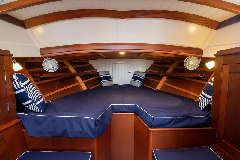 Marcy Yacht Photos Pics Luxurious cabin interior of 2021 Brooklin Boat Yard 32 Express with blue cushions and wood finish.