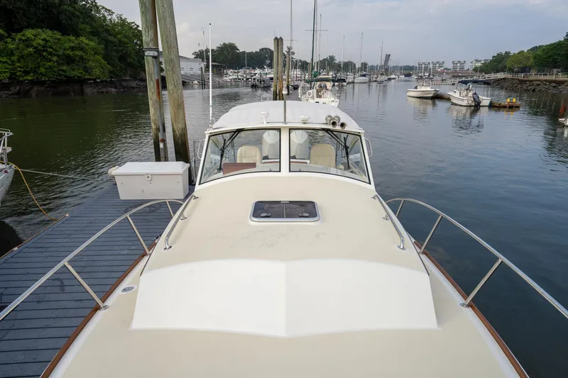 Marcy Yacht Photos Pics 2021 Brooklin Boat Yard 32 Express docked in a serene marina setting.