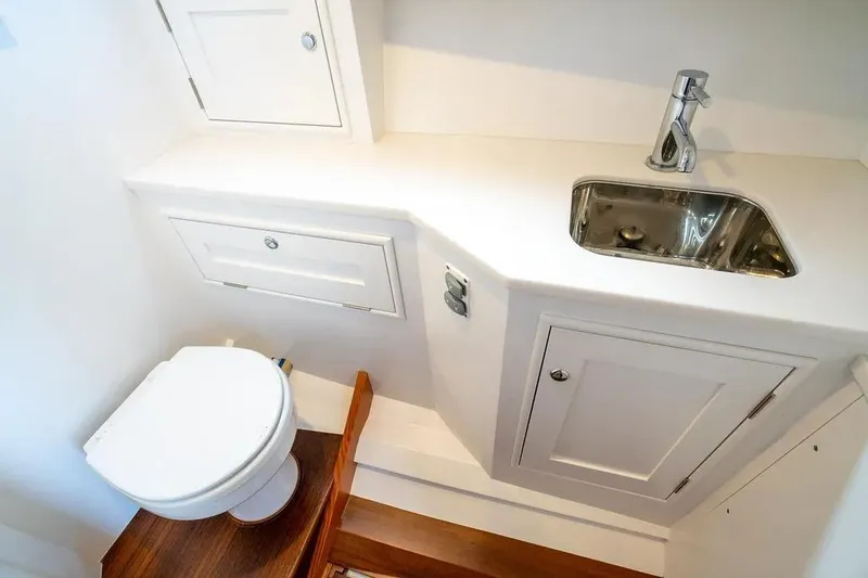 Marcy Yacht Photos Pics Compact bathroom in 2021 Brooklin Boat Yard 32 Express, featuring sink and toilet.