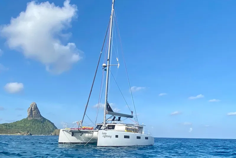 Lazy Lightning Yacht Photos Pics Sailing catamaran "Lazy Lightning" on ocean near island, Vision 444 model, 2021.