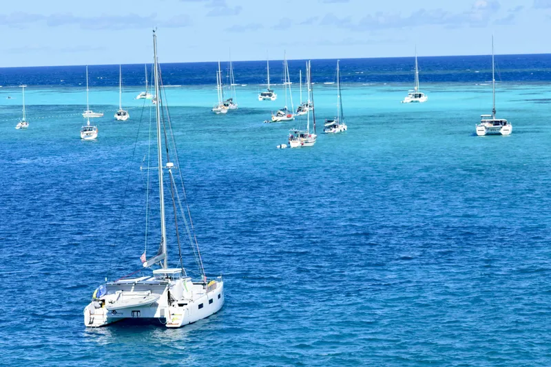 Lazy Lightning Yacht Photos Pics Sailboats anchored in clear blue ocean waters, Vision 444 model, 2021.