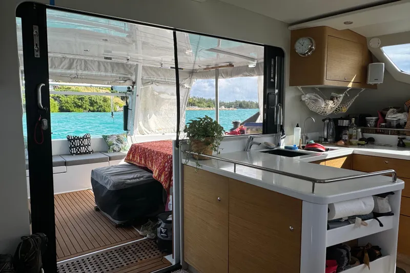 Lazy Lightning Yacht Photos Pics Interior of Vision 444 yacht, featuring kitchen and lounge area with ocean view.