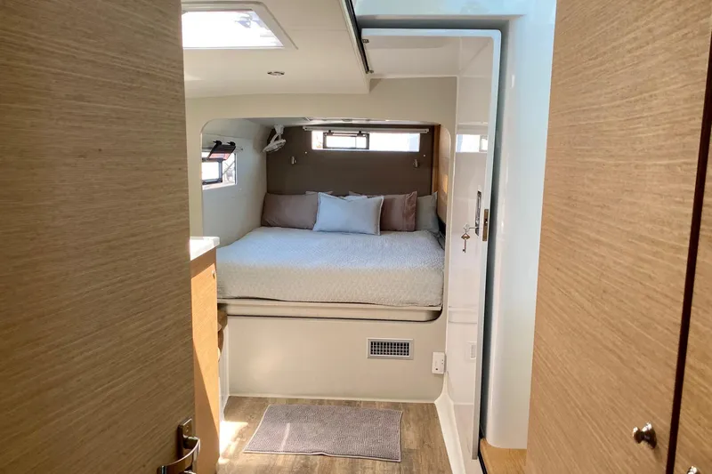 Lazy Lightning Yacht Photos Pics Cozy bedroom interior in 2021 Vision 444 yacht, featuring a comfortable bed and modern design.
