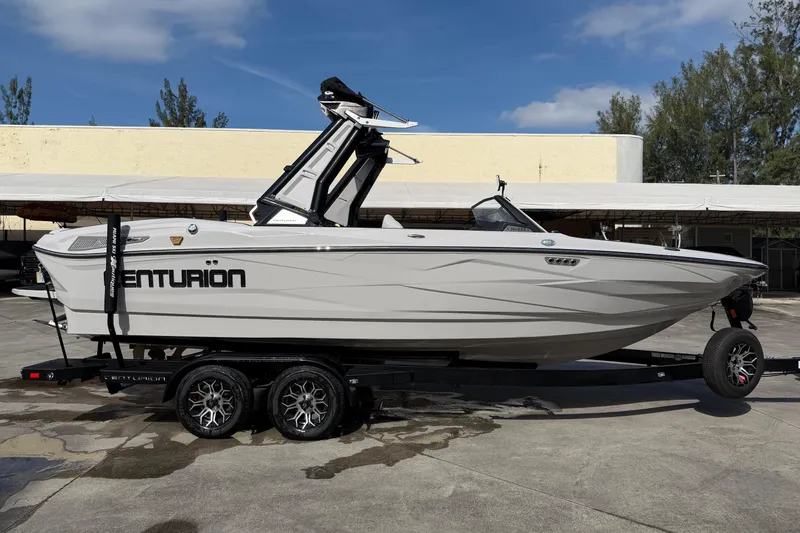  Yacht Photos Pics 2026 Centurion Nv233 boat on trailer, sleek design, parked outdoors.