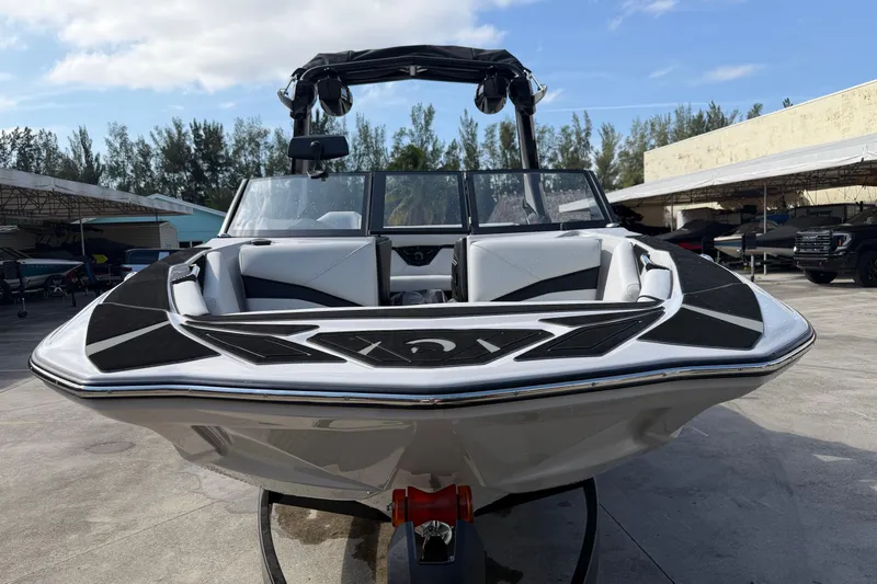  Yacht Photos Pics 2026 Centurion Nv233 boat with sleek design, parked outdoors on a sunny day.