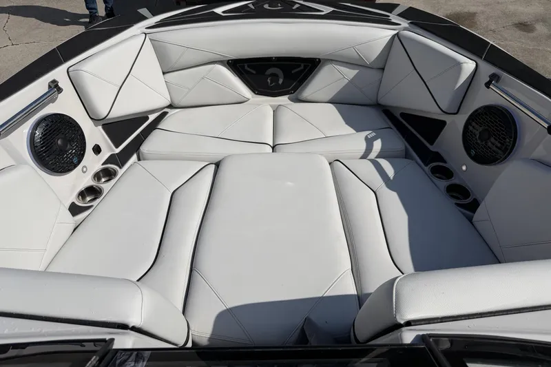  Yacht Photos Pics Luxurious interior of 2026 Centurion Nv233 boat with white leather seating and speakers.