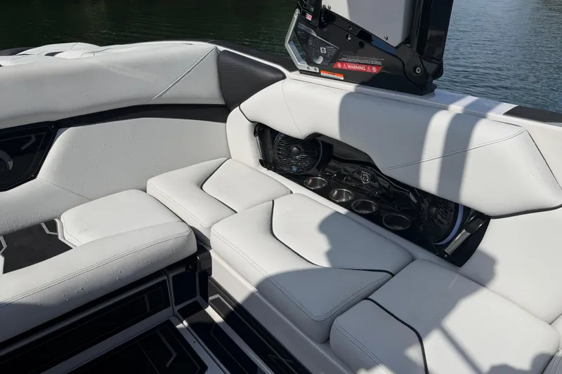  Yacht Photos Pics Luxurious seating area on 2026 Centurion Nv233 boat with cup holders and speakers.