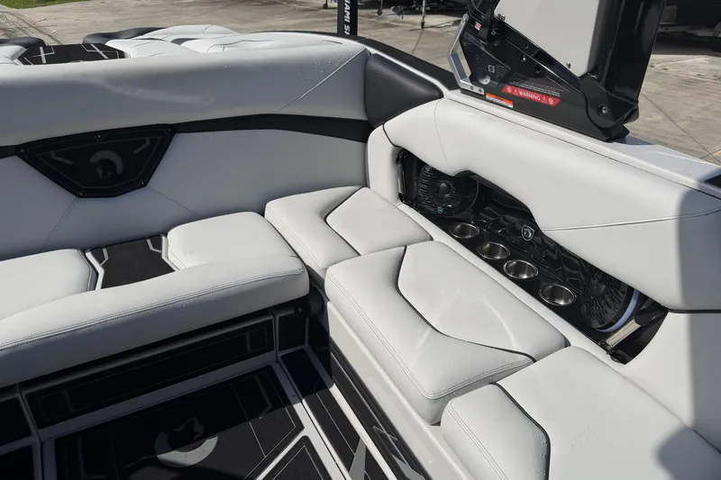  Yacht Photos Pics Luxurious interior of 2026 Centurion Nv233 boat with white seating and cup holders.