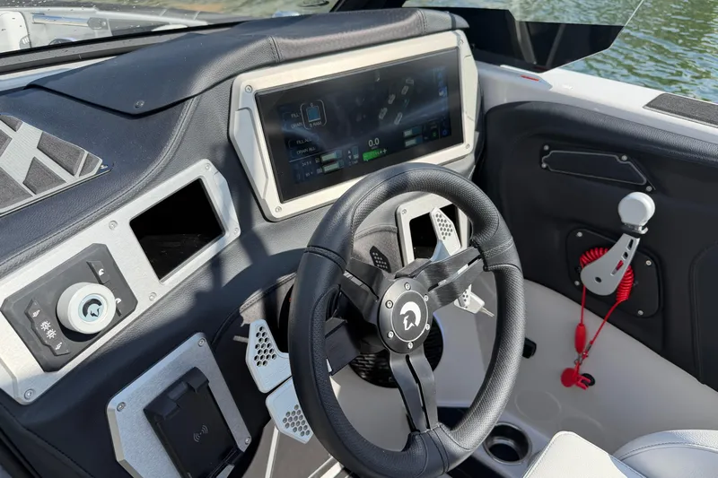  Yacht Photos Pics Cockpit of 2026 Centurion Nv233 boat with modern steering and digital display.