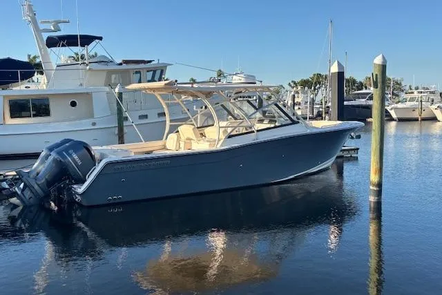  Yacht Photos Pics 2016 Grady-White Freedom 307 boat docked in a marina, clear blue sky.