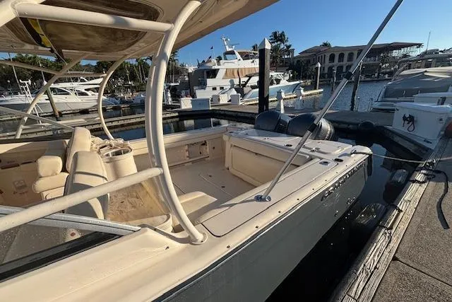  Yacht Photos Pics 2016 Grady-White Freedom 307 boat docked at marina, featuring spacious seating and dual engines.