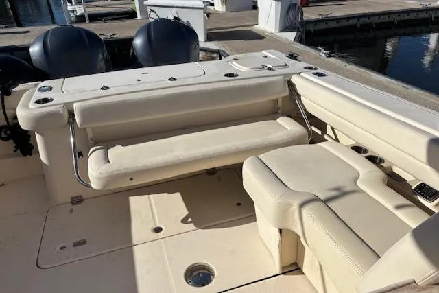  Yacht Photos Pics 2016 Grady-White Freedom 307 boat interior with seating and dual engines at dock.