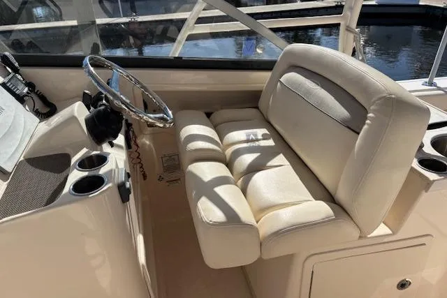  Yacht Photos Pics 2016 Grady-White Freedom 307 boat interior with steering wheel and cushioned seating.