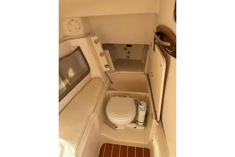  Yacht Photos Pics 2016 Grady-White Freedom 307 boat interior with toilet and seating area.