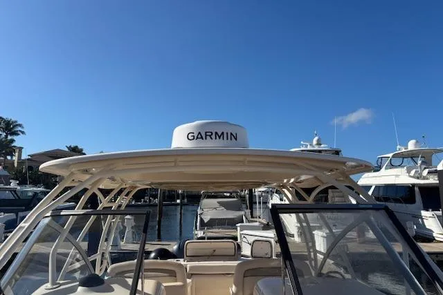  Yacht Photos Pics 2016 Grady-White Freedom 307 boat with Garmin equipment, docked under clear blue sky.