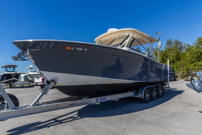  Yacht Photos Pics 2016 Grady-White Freedom 307 boat on trailer under clear blue sky.