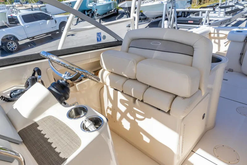 Yacht Photos Pics 2016 Grady-White Freedom 307 boat helm with plush seating and steering wheel.