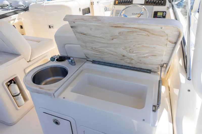  Yacht Photos Pics 2016 Grady-White Freedom 307 boat interior with sink and storage compartment.