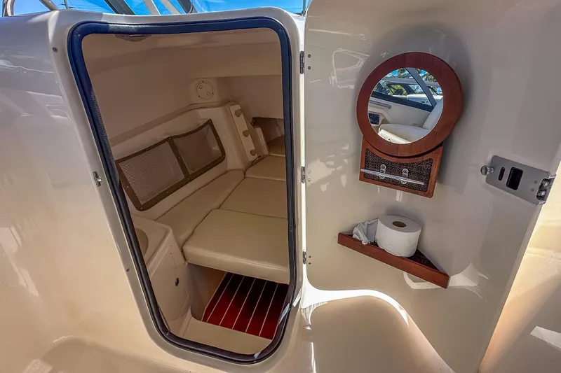  Yacht Photos Pics 2016 Grady-White Freedom 307 cabin interior with seating and mirror.