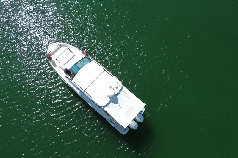  Yacht Photos Pics Aerial view of 2021 Regal 36 XO boat on green water.