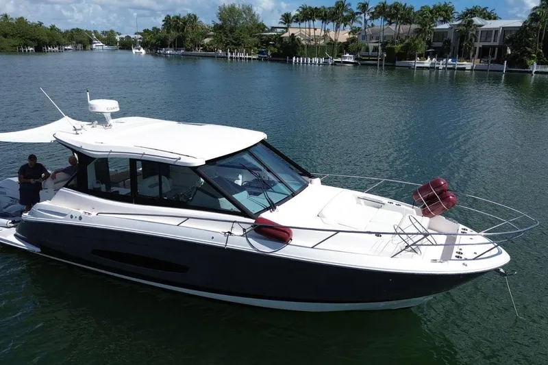  Yacht Photos Pics 2021 Regal 36 XO yacht cruising on a scenic waterway with lush greenery.