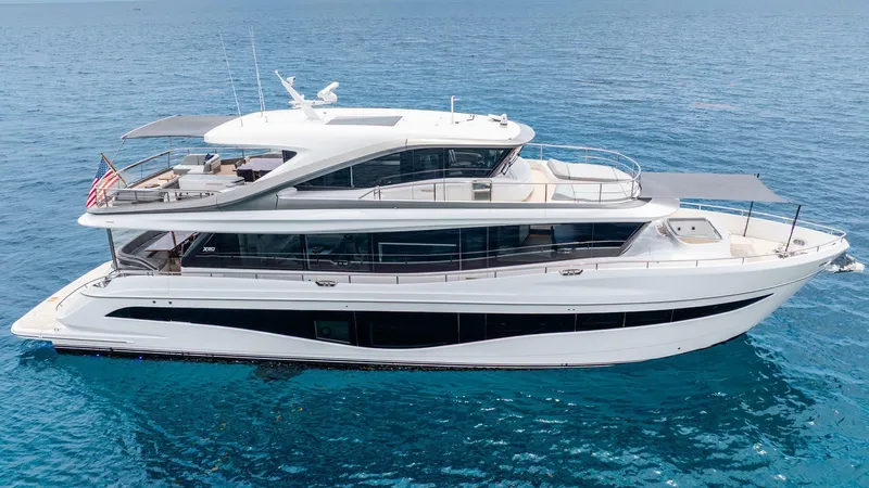 Cosa Bella Yacht Photos Pics Luxurious 2024 Princess X80 yacht cruising on clear blue ocean waters.