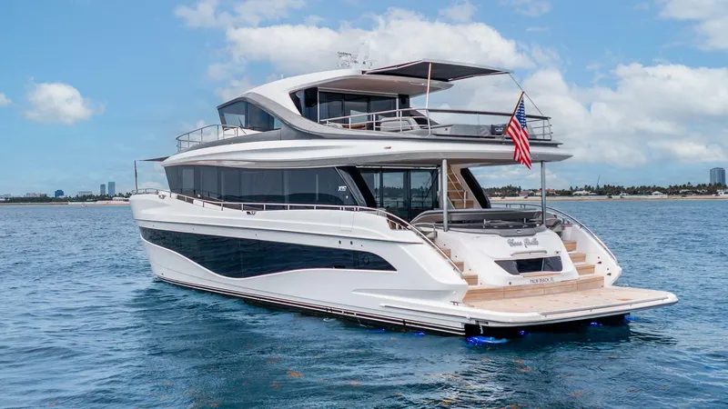 Cosa Bella Yacht Photos Pics Luxurious 2024 Princess X80 yacht cruising on open water under a clear blue sky.