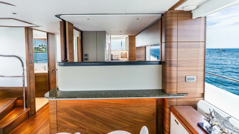 Cosa Bella Yacht Photos Pics Luxurious interior of 2024 Princess X80 yacht with wood finishes and ocean view.