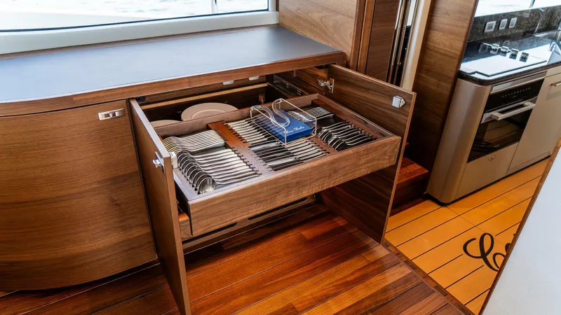 Cosa Bella Yacht Photos Pics Luxurious kitchen drawer with organized cutlery on the 2024 Princess X80 yacht.