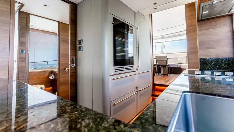 Cosa Bella Yacht Photos Pics Luxurious interior of 2024 Princess X80 yacht featuring modern kitchen and dining area.
