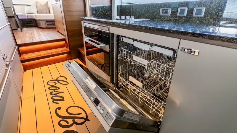 Cosa Bella Yacht Photos Pics Modern kitchen in 2024 Princess X80 yacht with open dishwasher and sleek design.
