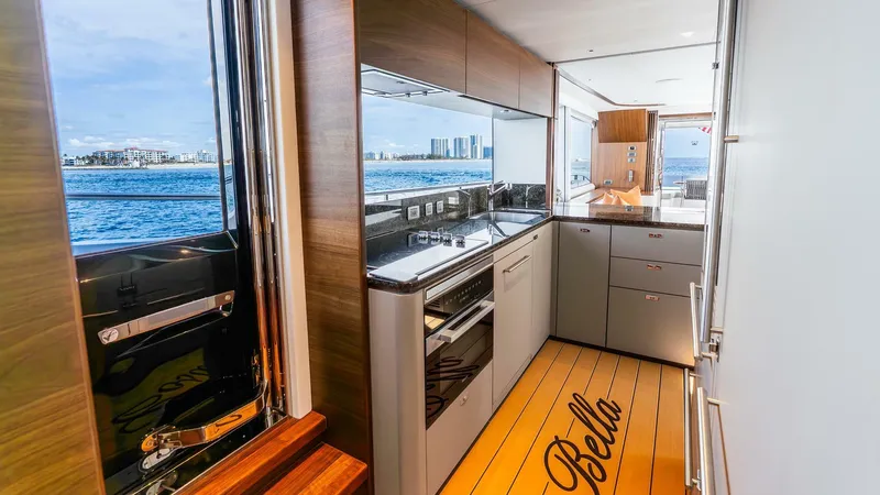 Cosa Bella Yacht Photos Pics Luxurious 2024 Princess X80 yacht interior with modern kitchen and ocean view.