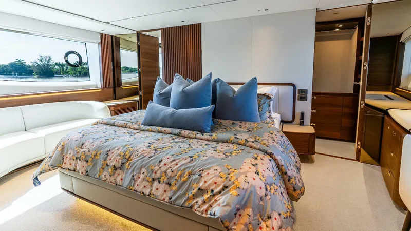 Cosa Bella Yacht Photos Pics Luxurious 2024 Princess X80 yacht bedroom with elegant decor and large windows.