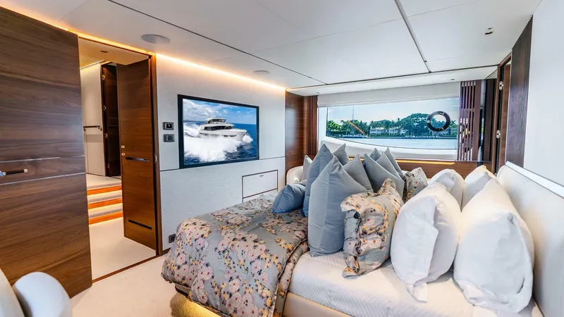 Cosa Bella Yacht Photos Pics Luxurious 2024 Princess X80 yacht bedroom with elegant decor and scenic window view.