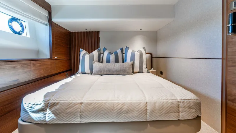 Cosa Bella Yacht Photos Pics Luxurious bedroom interior of 2024 Princess X80 yacht with elegant bedding and wood accents.
