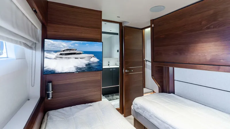 Cosa Bella Yacht Photos Pics Luxurious 2024 Princess X80 yacht cabin with twin beds and modern wood paneling.