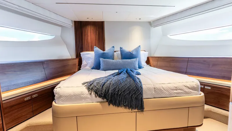 Cosa Bella Yacht Photos Pics Luxurious bedroom interior of 2024 Princess X80 yacht with elegant wood finishes and plush bedding.