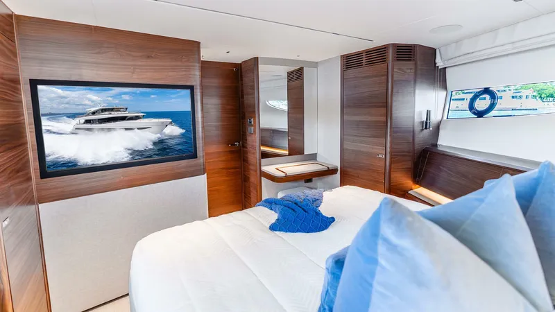 Cosa Bella Yacht Photos Pics Luxurious 2024 Princess X80 yacht bedroom with modern wood paneling and elegant decor.