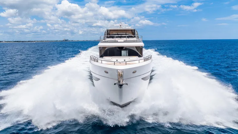 Cosa Bella Yacht Photos Pics 2024 Princess X80 yacht cruising on open sea under blue sky.