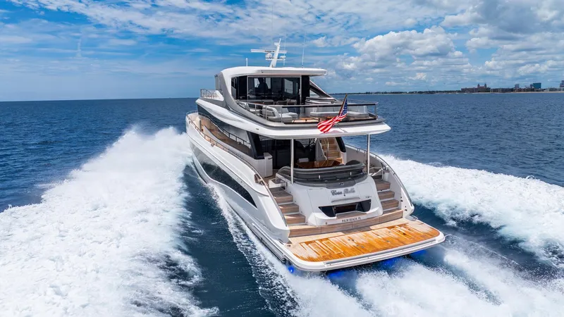 Cosa Bella Yacht Photos Pics 2024 Princess X80 yacht cruising on open sea under a clear blue sky.