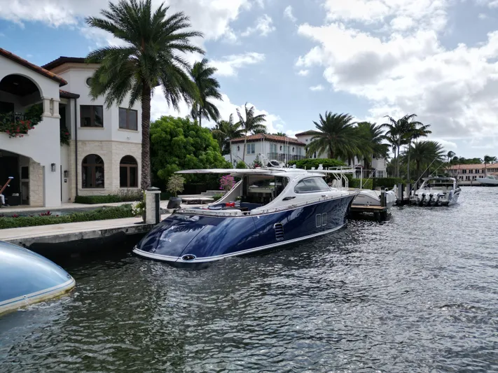Friendship Yacht Photos Pics 2023 Zeelander 5 yacht docked by luxury waterfront homes with palm trees.